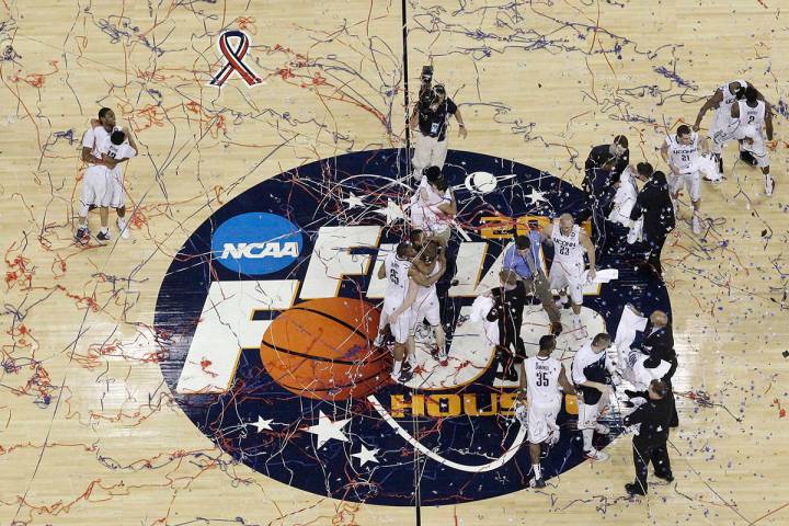 Connecticut celebrates after winning the men's NCAA Final Four college basketball championship ...