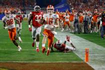 Clemson quarterback Trevor Lawrence runs in for a touchdown against Ohio State during the first ...