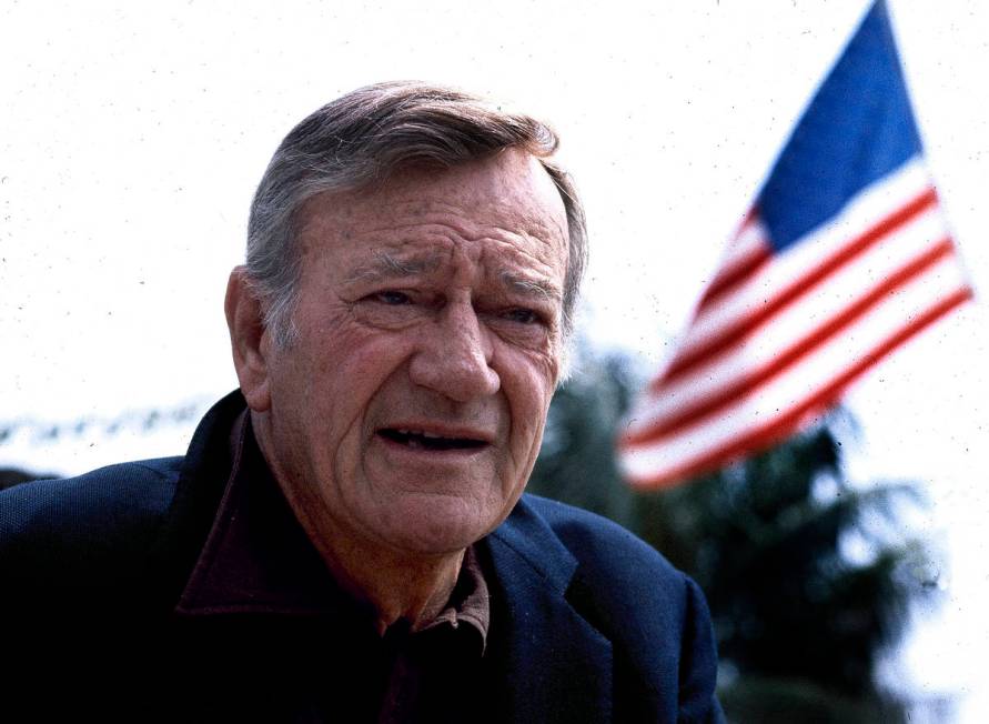 FILE - This 1978 file photo shows actor John Wayne. Wearing a brown plaid coat worn by Wayne in ...