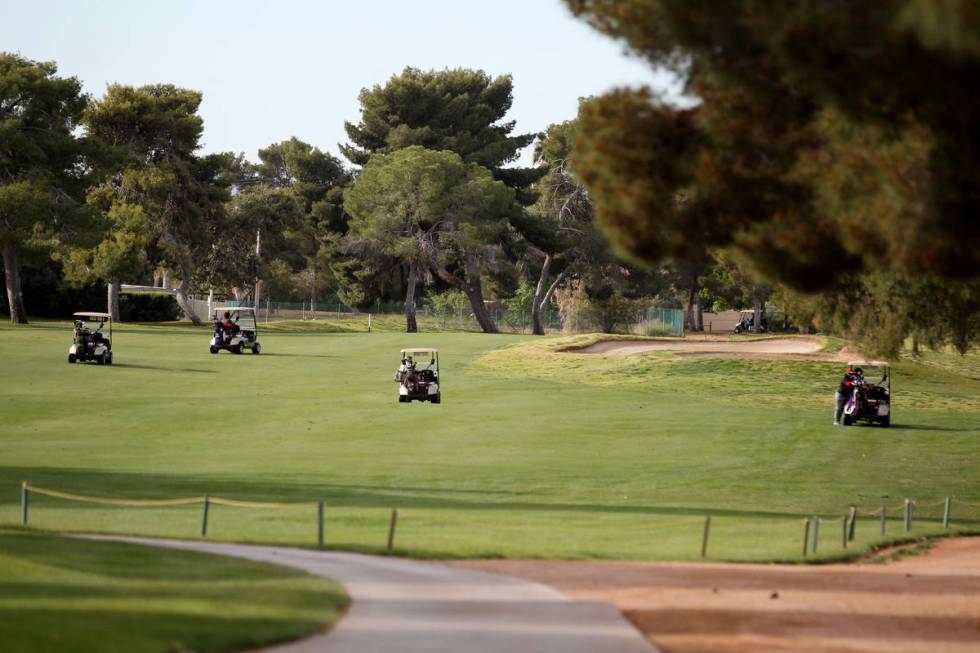 Golfers at Las Vegas National Golf Club Wednesday, April 8, 2020. Golf courses have closed club ...