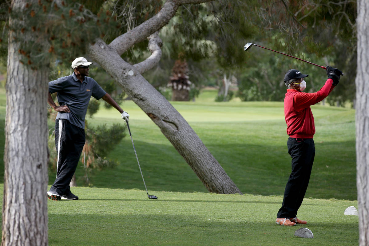 Golfers at Las Vegas National Golf Club Wednesday, April 8, 2020. Golf courses have closed club ...