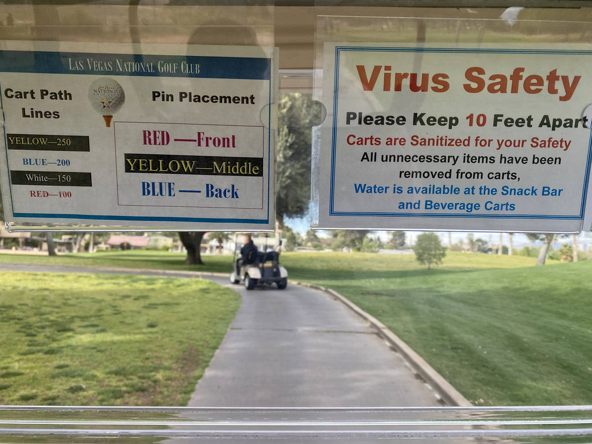 A social distancing sign in a golf cart at Las Vegas National Golf Club Wednesday, April 8, 202 ...