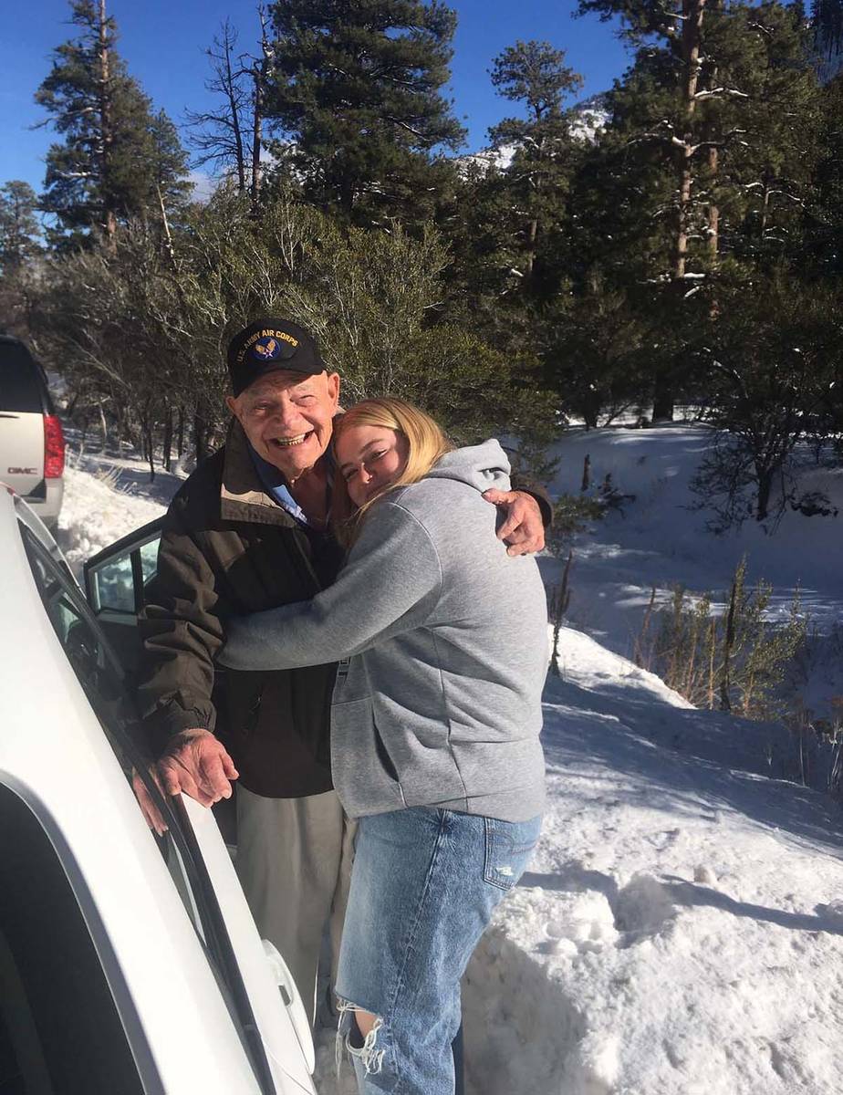 WWII Army veteran Edward Turken, 96, plays with his granddaughter, Emma, in the snow on Mount C ...