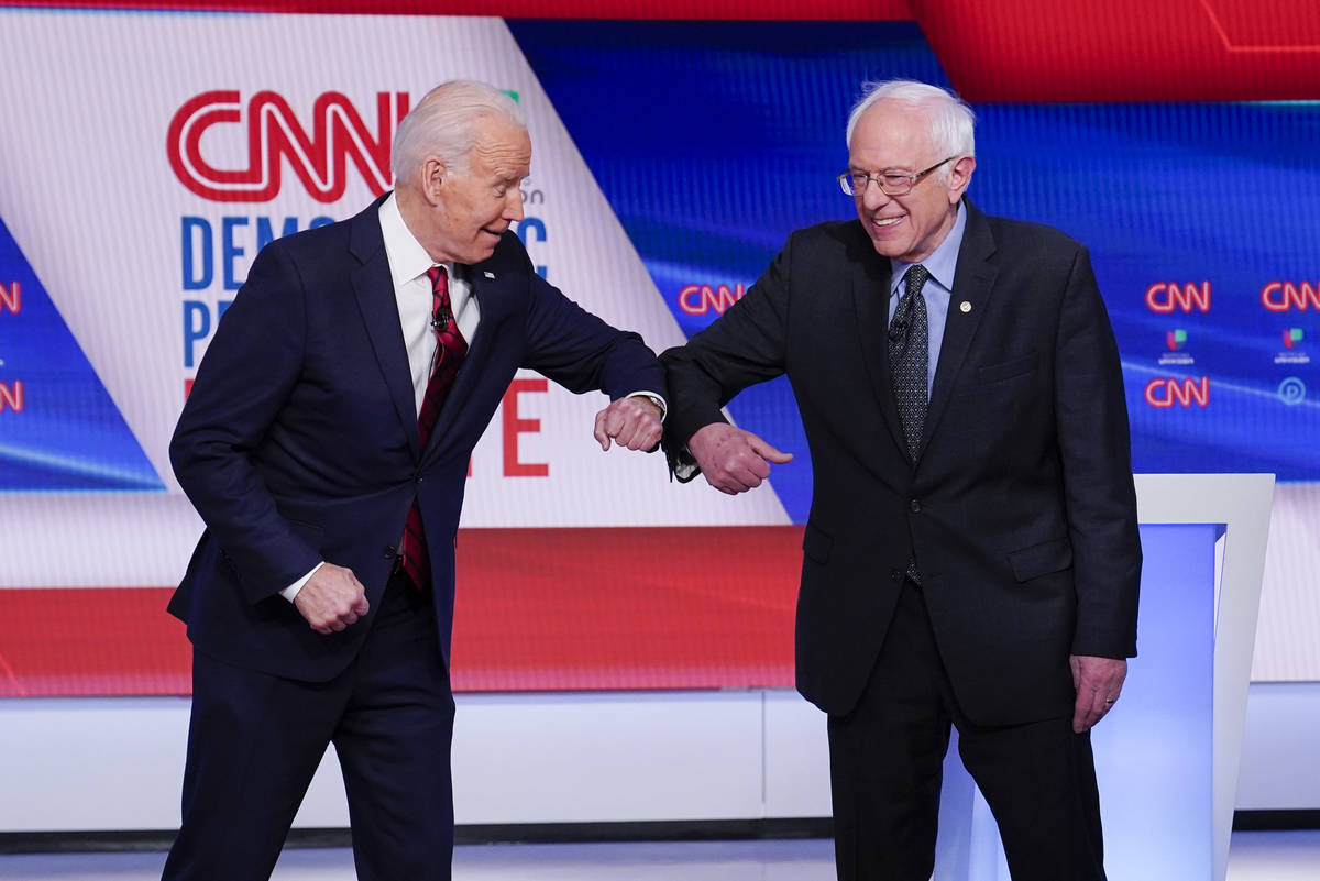 Former Vice President Joe Biden, left, and Sen. Bernie Sanders, I-Vt., right, greet one another ...