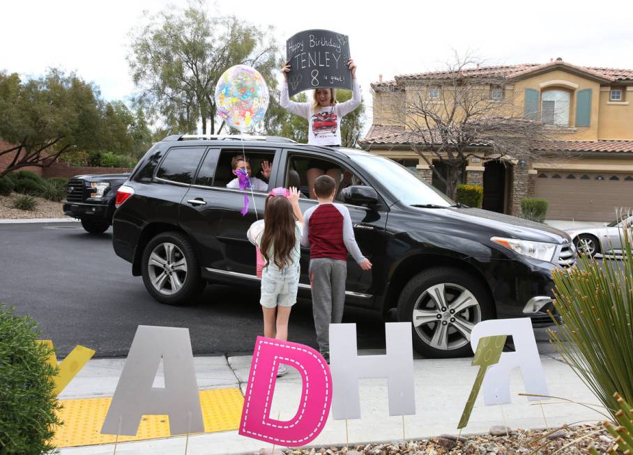 Tenley Hynds, left, waves to Aba Rogers, 16, top right, and Alex, 13, who came to celebrate her ...