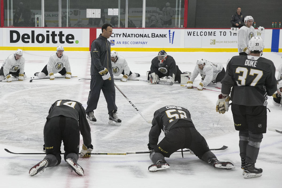 Vegas Golden Knights' forward Reid Duke (37) listens to the Chicago Wolfs' coach Rocky Thompson ...