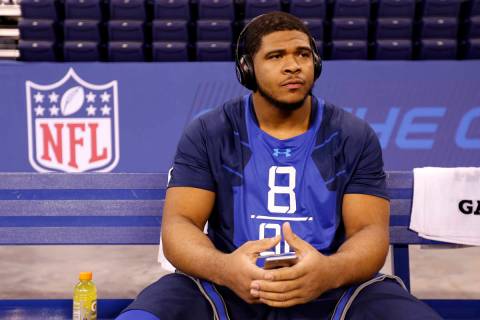 La'el Collins sits on a bench at the NFL football scouting combine in Indianapolis on Feb. 20, ...