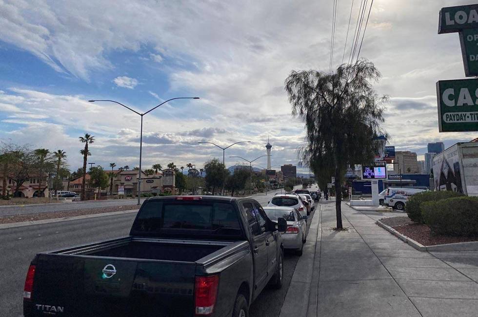 A line of cars estimated at several miles long line West Sahara Avenue as occupants wait for fo ...