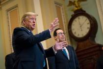 In a March 10, 2020, file photo, Treasury Secretary Steven Mnuchin listens as President Donald ...