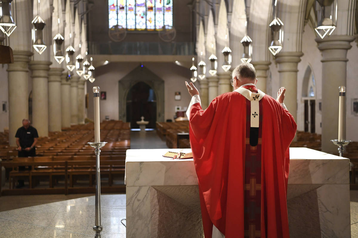 Archbishop Mark Coleridge delivers a Good Friday mass to an empty St. Stephen's Cathedral in Br ...