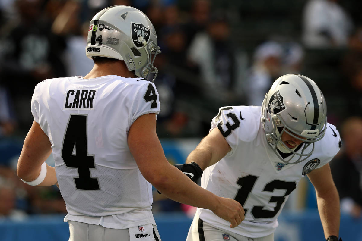 Oakland Raiders quarterback Derek Carr (4) comes to celebrate his touchdown pass with wide rece ...