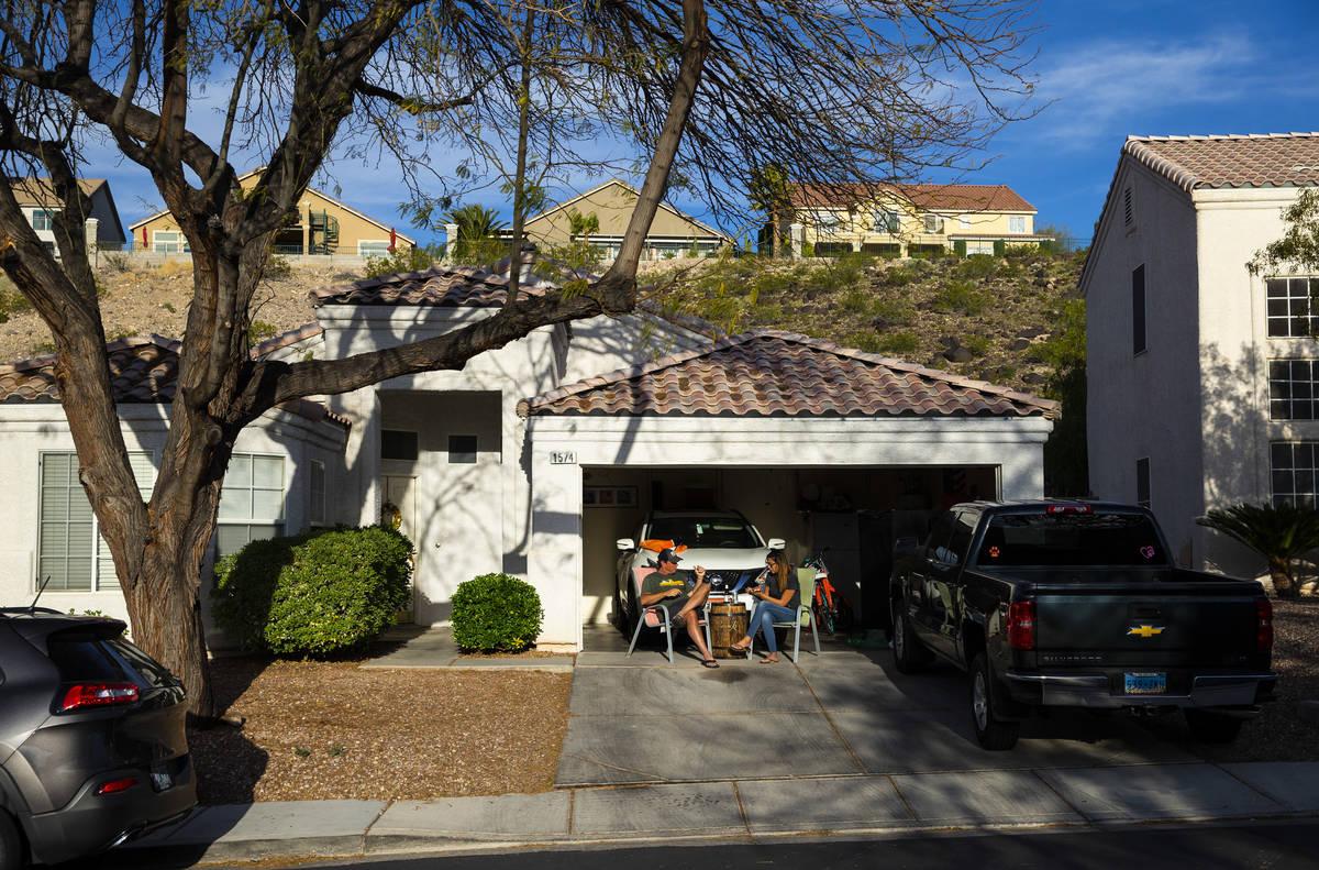 Marc Heldoorn and Lauren Heldoorn relax outside of their home while participating in a neighbor ...