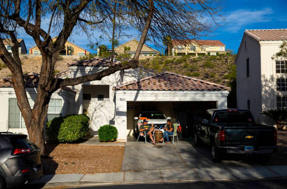 Marc Heldoorn and Lauren Heldoorn relax outside of their home while participating in a neighbor ...