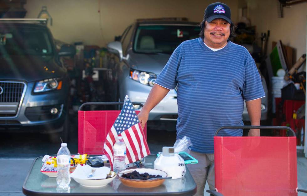 Noel Eusebio enjoys the weather outside of his home while participating in a neighborhood front ...