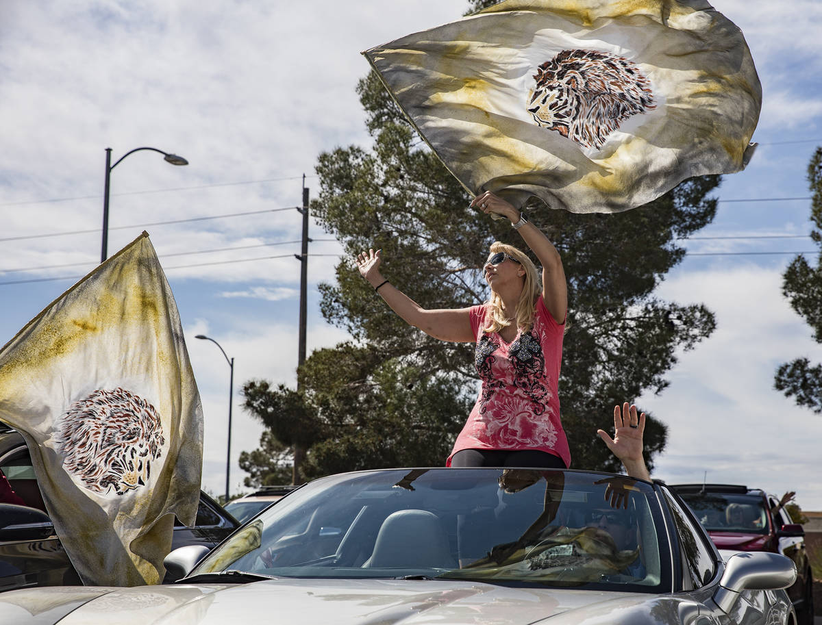 Pam Dunleavy waves a flag as she worships with her husband Dr. Sean Dunleavy at an Easter servi ...