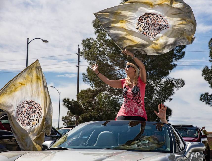 Pam Dunleavy waves a flag as she worships with her husband Dr. Sean Dunleavy at an Easter servi ...