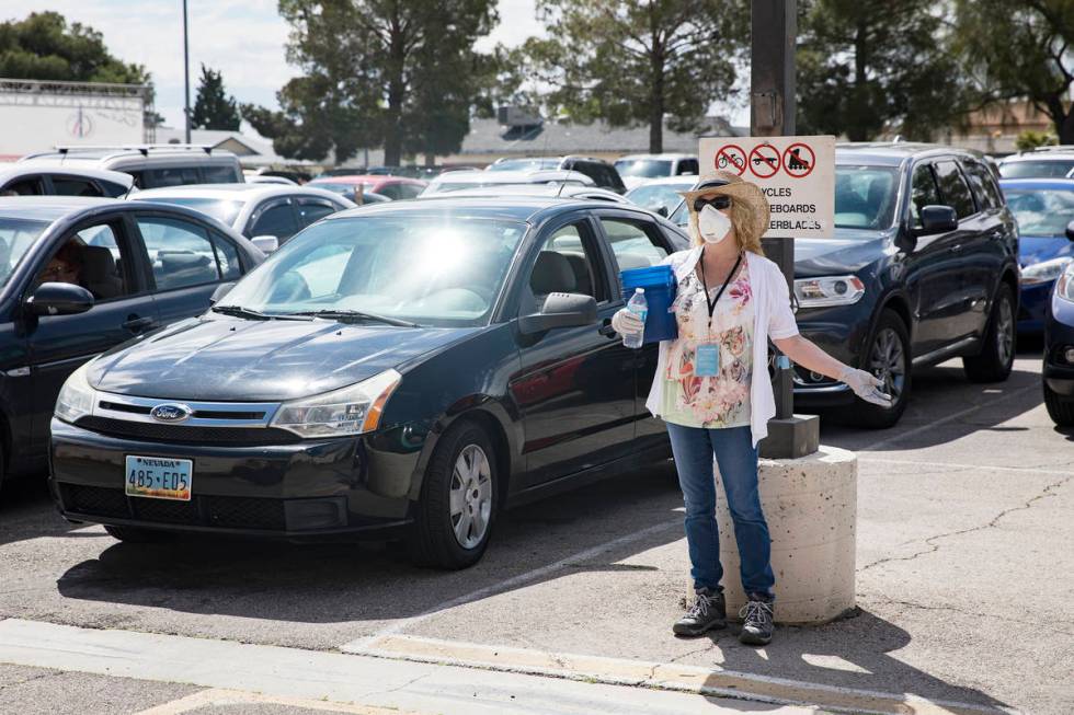 Usher Deborah Withrow worships alongside guests in their cars at an Easter service in the parki ...