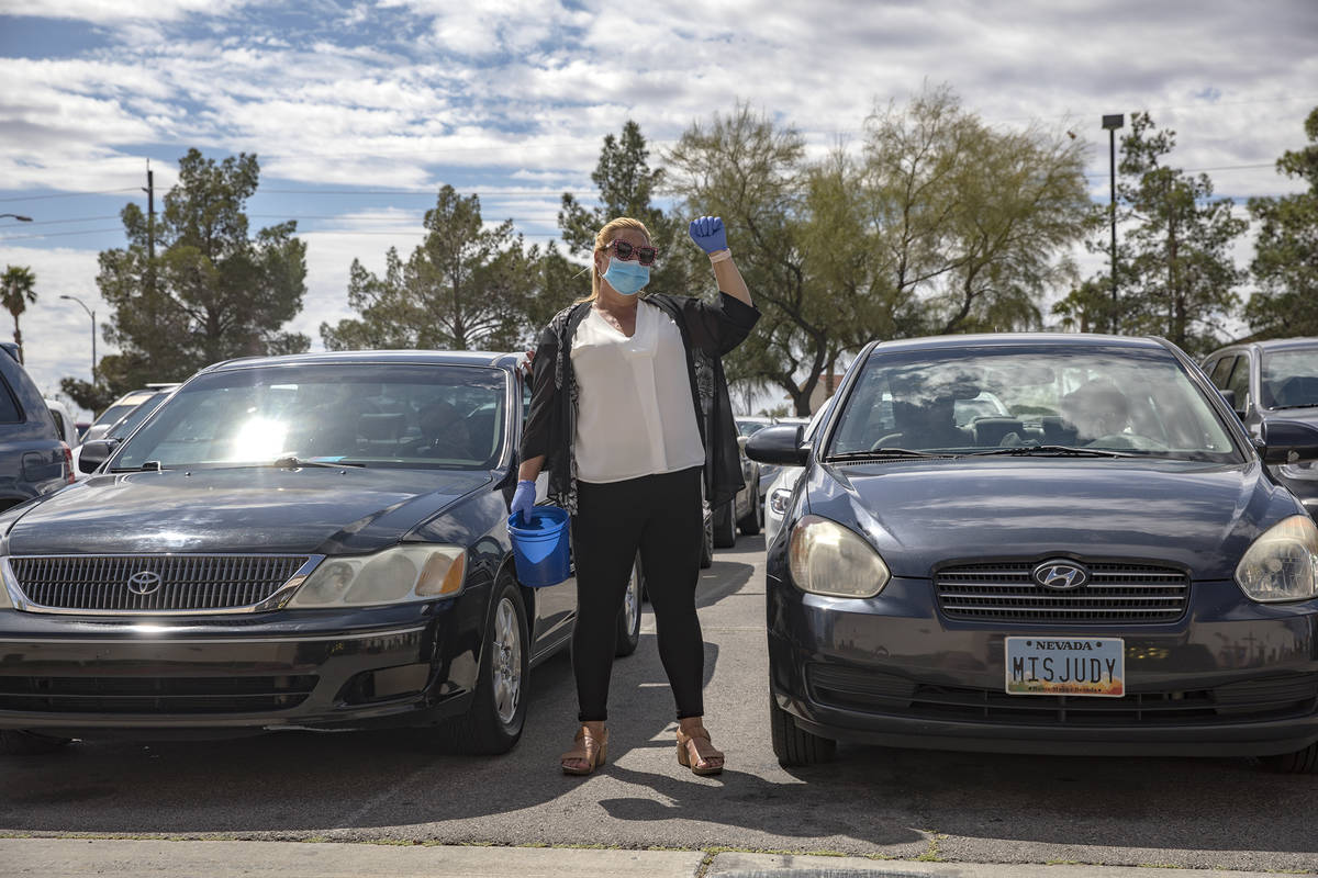 Usher Cathleen Snyder worships alongside guests in their cars at an Easter service in the parki ...