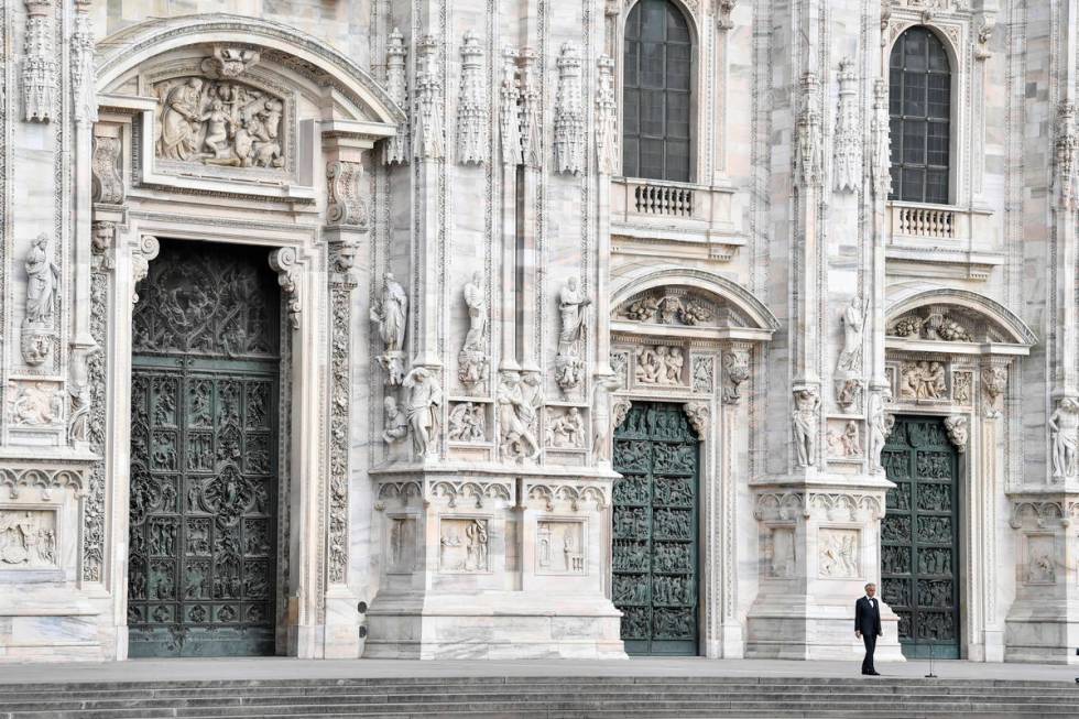 Italian singer Andrea Bocelli performs outside the Duomo cathedral, on Easter Sunday, in Milan, ...