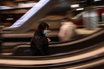 A commuter wearing a face mask to protect against coronavirus at Atocha train station in Madrid ...