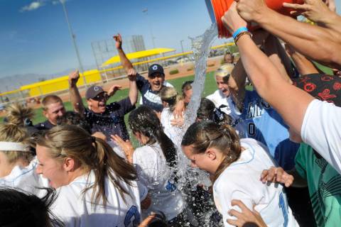 Centennial High School softball team members get doused with ice water by fans as the celebrate ...