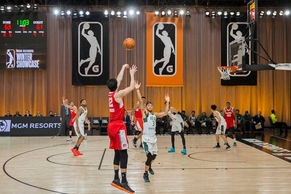 Memphis Hustle forward Yuta Watanabe (12) shoots a three point shot over Wisconsin Herd guard J ...