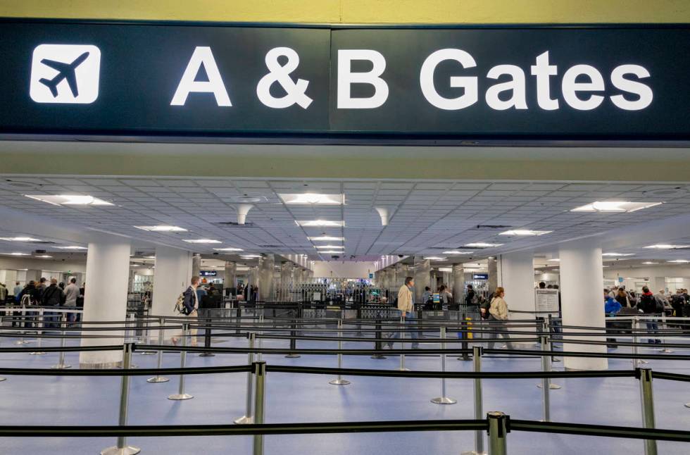 Passengers enter a security queue at McCarran International Airport in Las Vegas on Thursday, M ...