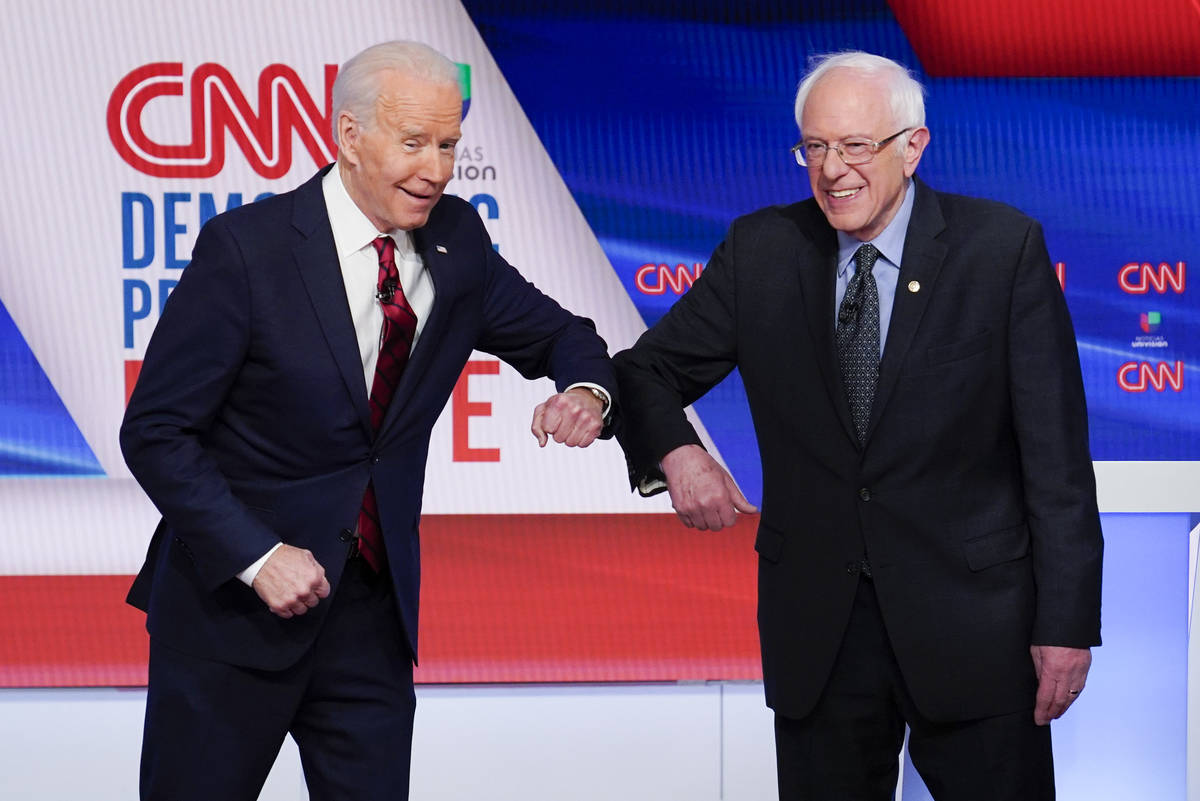 Former Vice President Joe Biden, left, and Sen. Bernie Sanders, I-Vt., right, greet each other ...