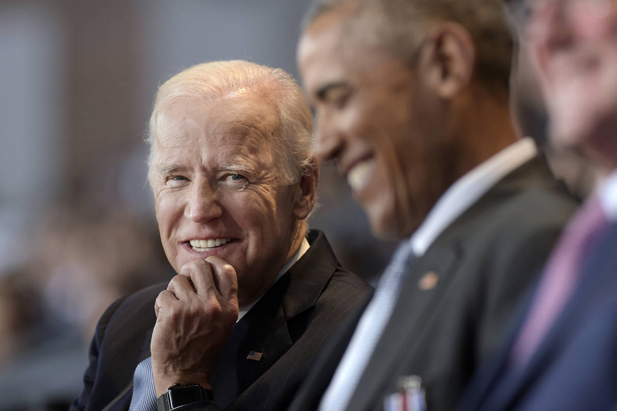 In a Jan. 4, 2017, file photo, Vice President Joe Biden, left, watches President Barack Obama, ...