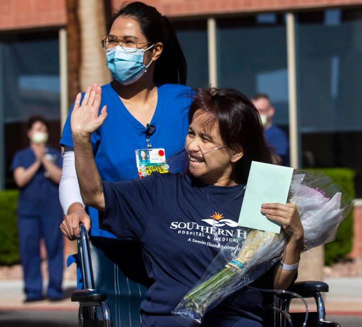 MountainView Hospital nurse Bessy Angue, bottom/right, is wheeled out of Southern Hills Hospita ...