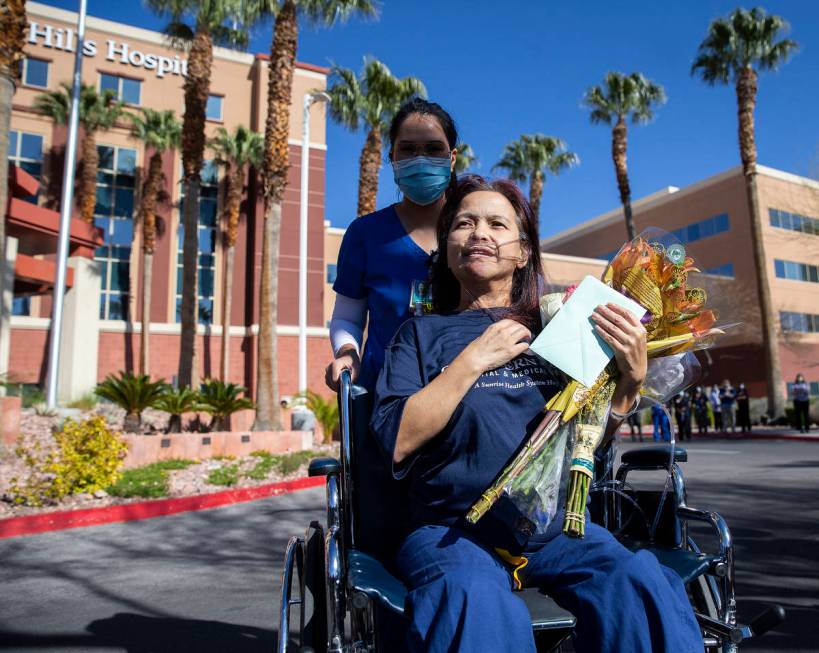 MountainView Hospital nurse Bessy Angue, bottom/right, is wheeled out of Southern Hills Hospita ...