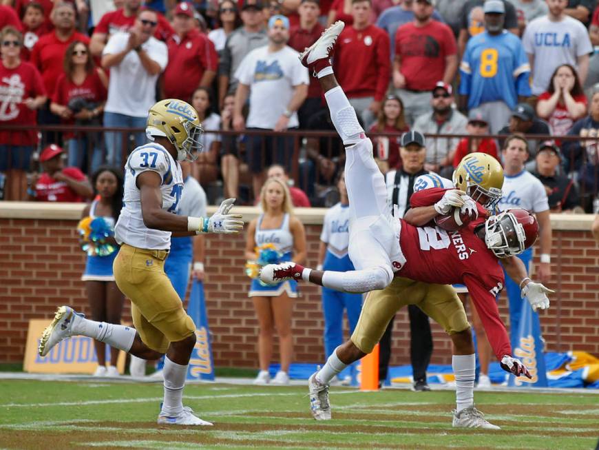 Oklahoma wide receiver CeeDee Lamb (2) comes down with a touchdown pass in front of UCLA defens ...