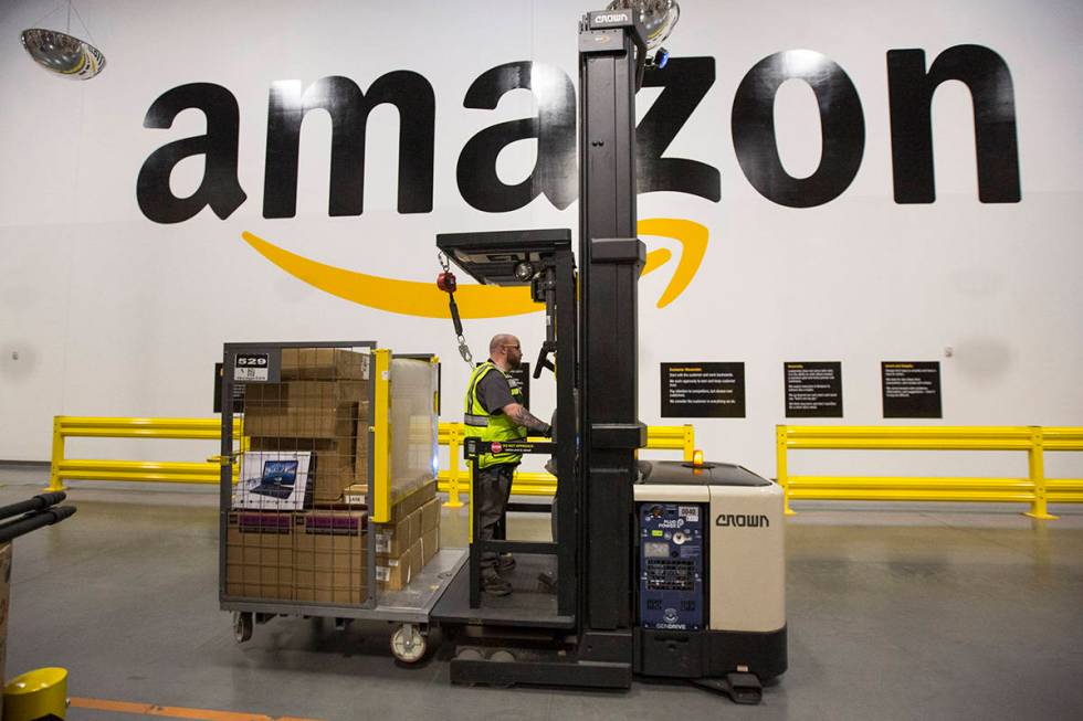 A forklift driver navigates through Amazon's North Las Vegas fulfillment center on Thursday, De ...