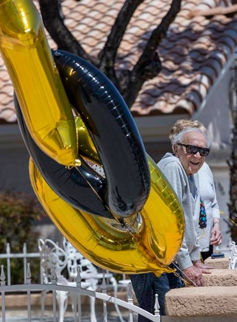 Henry Kronberg looks to friends stopping by his home to help him celebrate his 100th birthday d ...