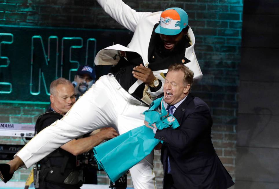 Clemson defensive tackle Christian Wilkins moves into NFL Commissioner Roger Goodell after the ...