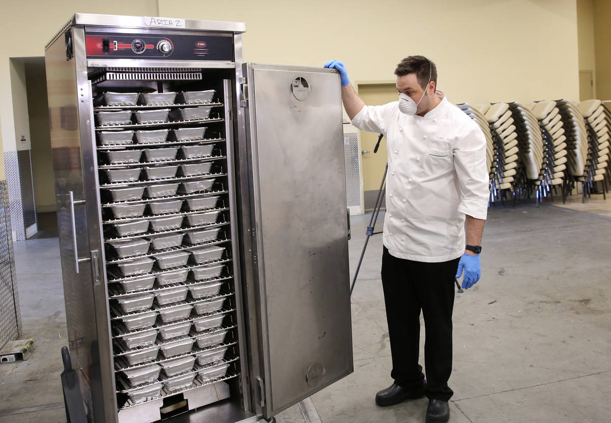 Thomas Griese, executive chef at Sage Restaurant, displays hot meals, prepared by chefs from th ...