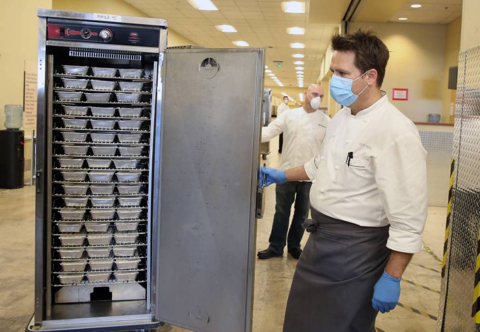 David Werly, executive chef at Aria hotel-casino, displays hot meals, prepared by chefs from th ...