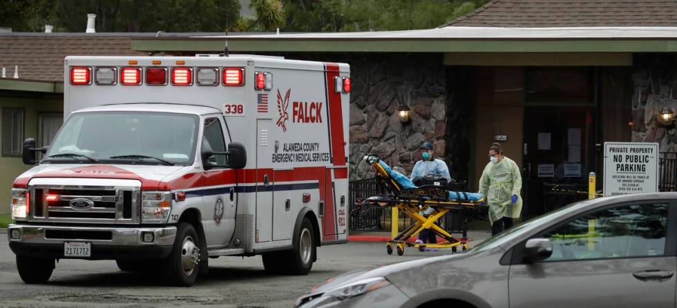 EMT's move a stretcher at the Gateway Care and Rehabilitation Center on Thursday, April 9, 2020 ...