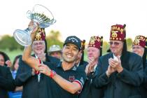 Kevin Na, center, holds up his trophy after winning the tournament at the final round of Shrine ...