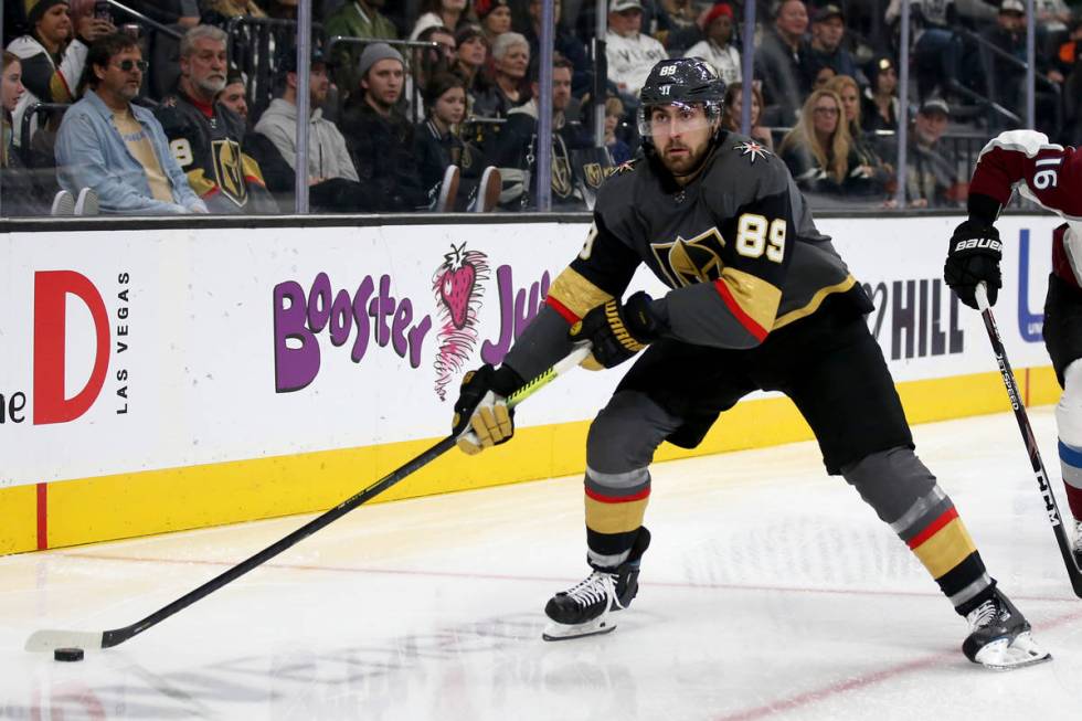 Vegas Golden Knights right wing Alex Tuch (89) moves the puck in front of Colorado Avalanche de ...