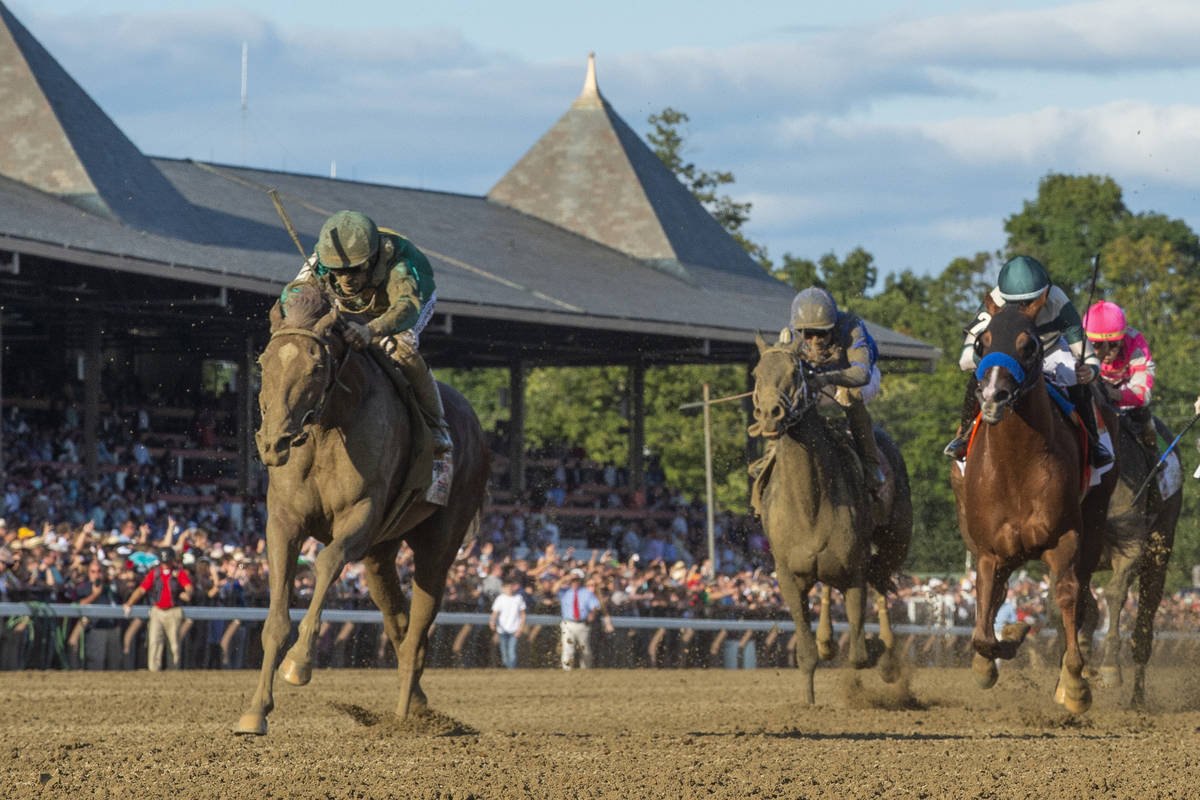 FILE- In this Aug. 24, 2019, file photo, Code of Honor, left, with jockey John Velazquez, leads ...