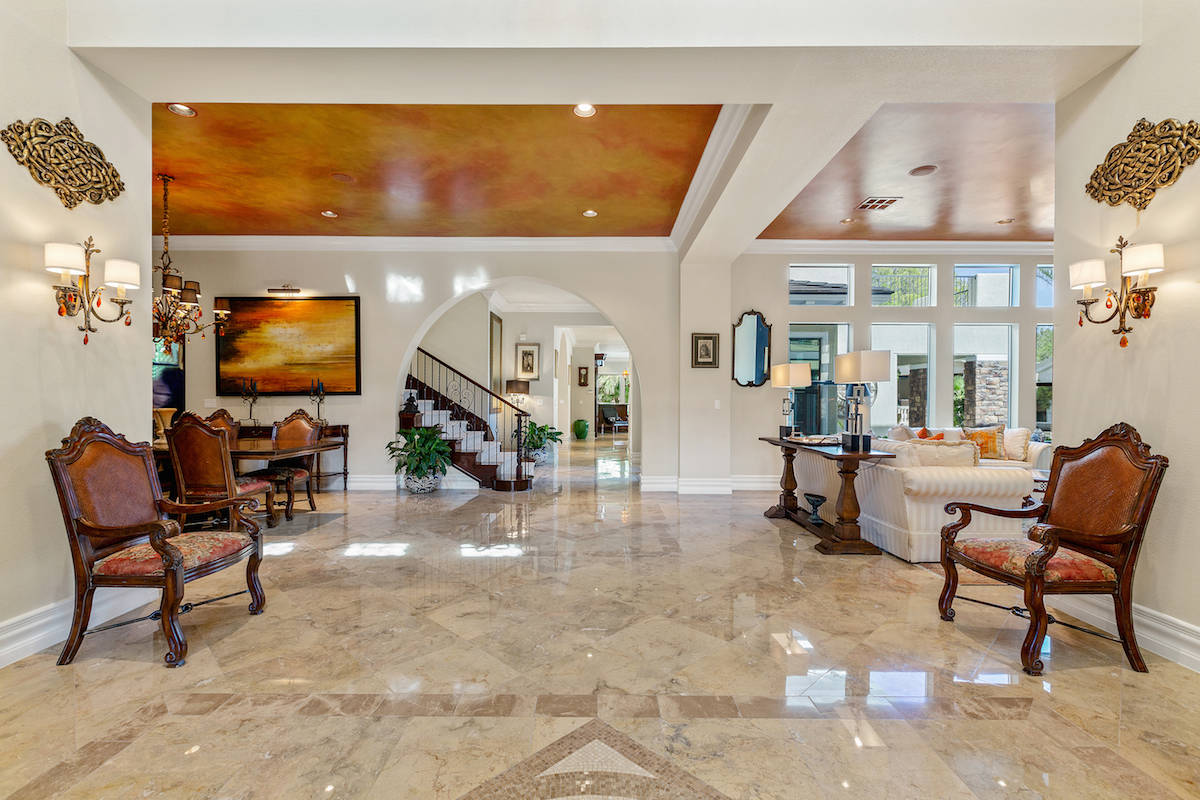 The home's living areas showcase Sierra Gold marble floors. (Tom Love Group)