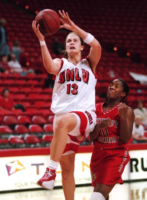 Lady Rebel Linda Frohlich (13) drive for two past SMS's Moneik Campbell (10) on a fast break du ...