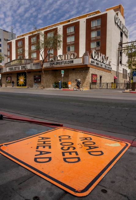 A cyclist rides past the Gold Spike along a quiet E. Ogden Avenue in Downtown Las Vegas during ...