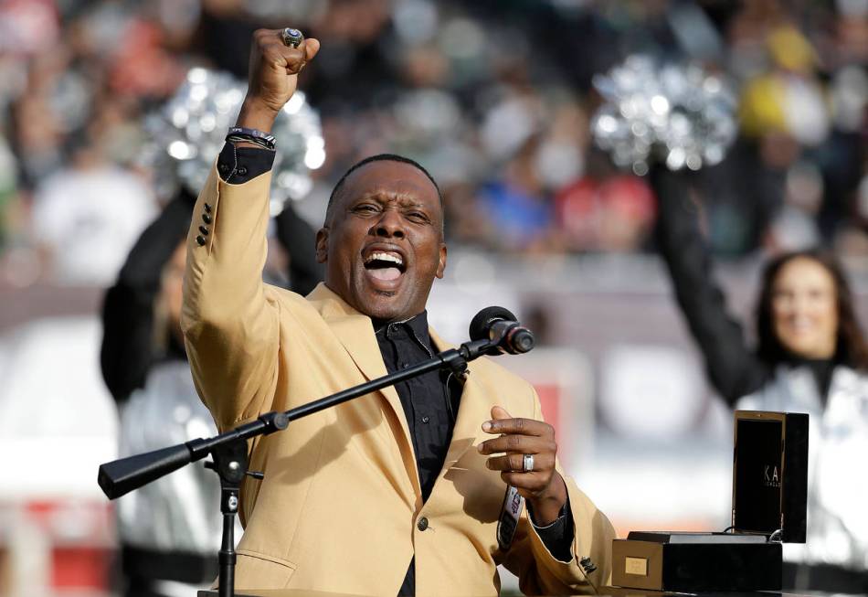 Former Oakland Raiders wide receiver Tim Brown gestures while speaking at a ceremony honoring h ...