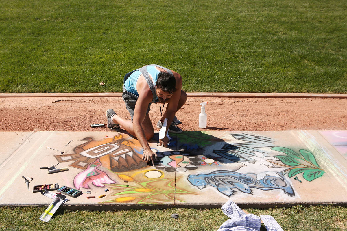 Kris Relph works on his chalk art in part of Chalk and Cheers at Skye Canyon Park in Las Vegas, ...