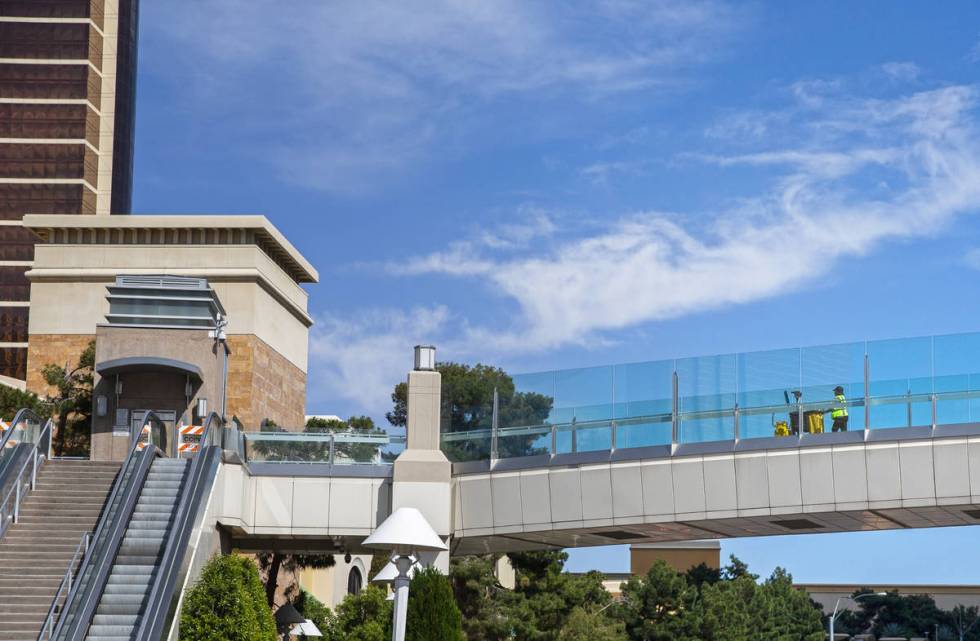 A maintenance worker crosses a pedestrian bridge on the Strip on Thursday, April 16, 2020, in L ...