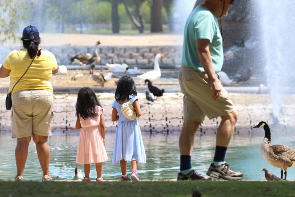 People, including Rosario Osagara, left, and her granddaughters Aba Miyu, left, 3, and Rosario, ...