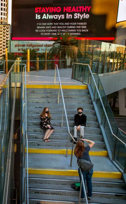 Holly Snyder, left, and Aaron Underwood have their graduation photos taken by Tiffannie Bond ne ...