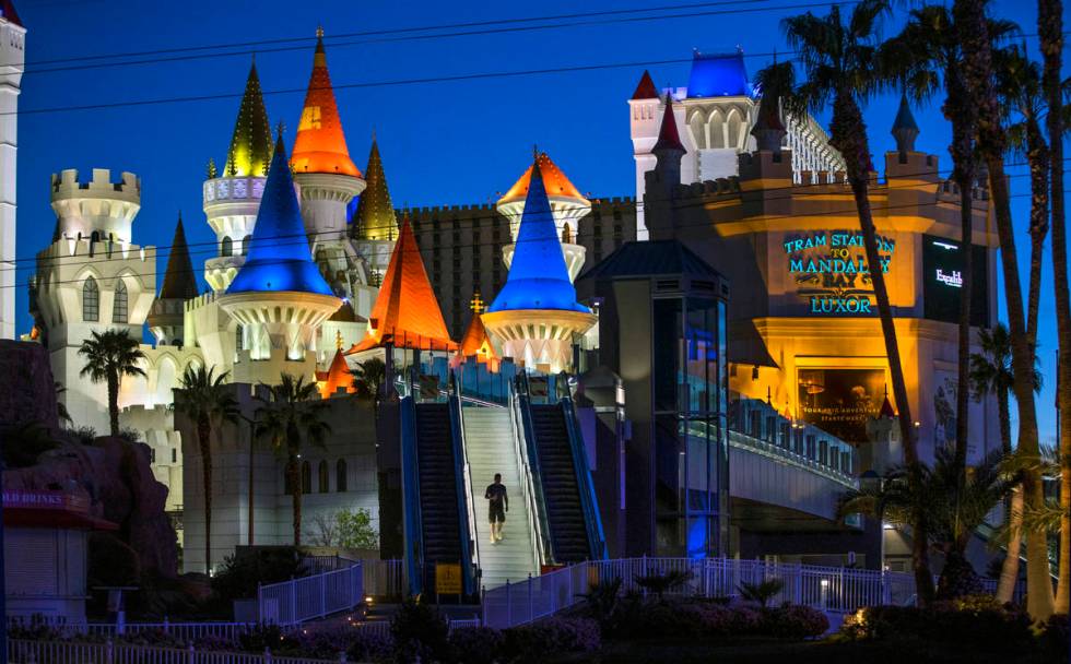 A pedestrian walks down from the bridge across from the Excalibur at Las Vegas Boulevard on the ...